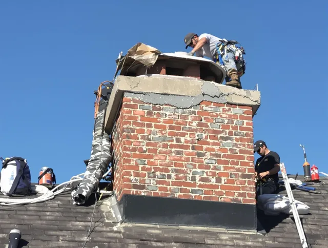 Westborough Chimney Sweep installing a custom chimney crown in Westborough, MA